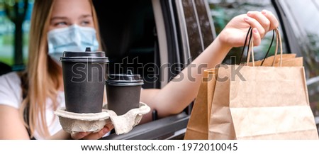 Food delivery home. Covid 19, quarantine. Contactless delivery in a pandemic. Safety. Delivery courier with order.curbside pickup Royalty-Free Stock Photo #1972010045