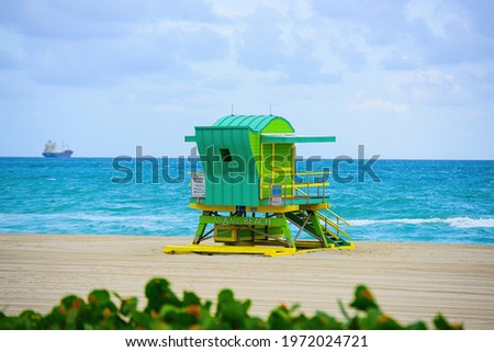 Miami South Beach lifeguard tower and coastline with cloud and blue sky.
