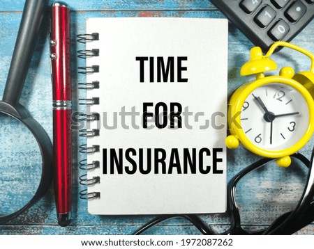 Business concept.Text TIME FOR INSURANCE with clock,glasses,magnifying glass,pen and calculator on blue wooden background.