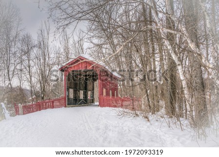 A picture of a beautiful red house in winter
