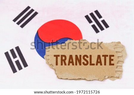 Business and finance concept. Against the background of the South Korean flag lies cardboard with the inscription - Translate