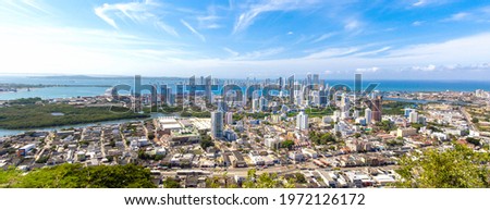 Flag wavering in front of scenic view of Cartagena modern skyline near historic city center and resort hotel zone. Royalty-Free Stock Photo #1972126172