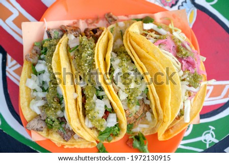 A plate of authentic Mexican tacos at a taco stand.