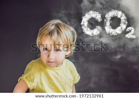 Boy turns his face away from the cigarette smoke CO2 lettering made of clouds isolated on black. Sky with CO2 pollution, smog
