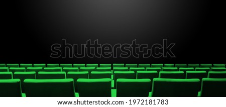 Cinema movie theatre with green seats rows and a black copy space background. Horizontal banner