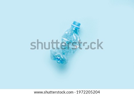used plastic bottle on a blue background. The concept of using plastic. Environmental problem, global environment. Top view, flat lay.  Royalty-Free Stock Photo #1972205204