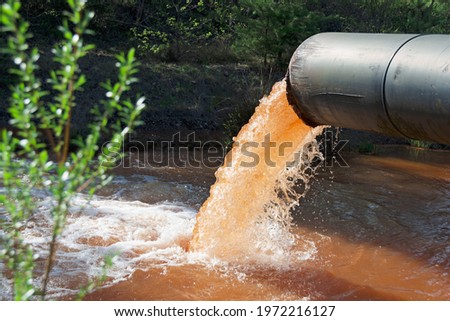 Wastewater is discharged into the river  Royalty-Free Stock Photo #1972216127