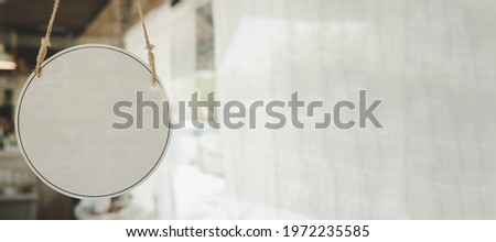 panoramic wide banner. blank vintage wooden sign board hanging on glass door in modern cafe restaurant, copy space for text advertising, advertisement marketing and small business owner concept