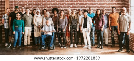 Group of diverse people standing in front of a brick wall Royalty-Free Stock Photo #1972281839