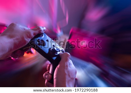 gamer playing game by joystick with computer, gaming and esports challenge, streaming online, tournament concept Royalty-Free Stock Photo #1972290188