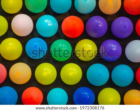 The colorful balloons at the shooting range at the amusement park Royalty-Free Stock Photo #1972308176