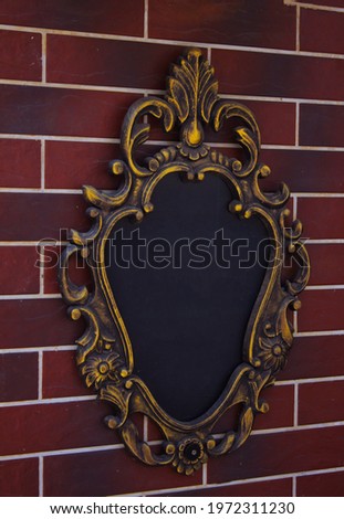 Frame for inscriptions on a brick wall, signboard. Black background for inscriptions, advertisements and advertisements, houses, place for text. Board, letterhead, template, layout, layout for slogan 