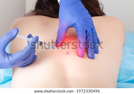 Cerebrospinal injection with ozone to relieve pain and inflammation in the back. Treatment of osteochondrosis and arthrosis of the spine with blockade therapy, chondroprotector Royalty-Free Stock Photo #1972330496
