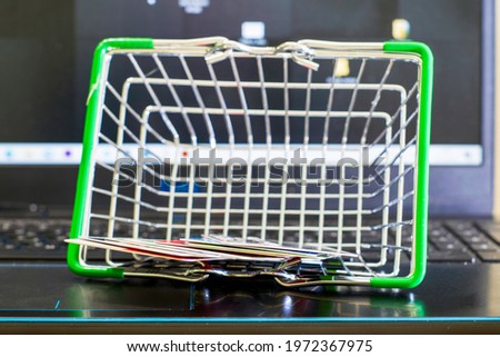 online shopping concept shopping cart on the laptop keyboard in the shopping cart credit cards. High quality photo