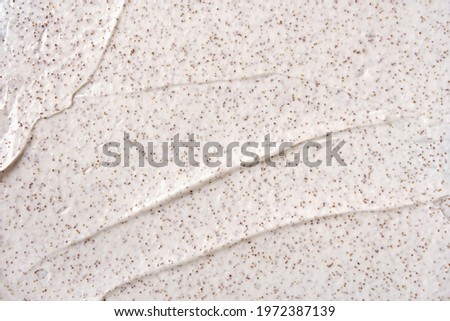 Texture of organic white scrub with Exfoliating coffee particles. Close-up Royalty-Free Stock Photo #1972387139