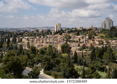 Mishkenot Sha'ananim and Yemin Moshe are the first jewish neighborhoods built outside of the old Jerusalem walls. Neighborhoods of modern Jerusalem are in the background. Royalty-Free Stock Photo #1972388489