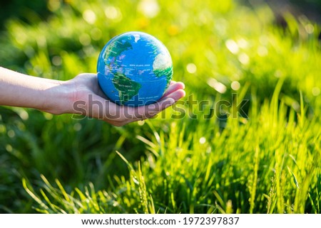 hand holding globe Earth day