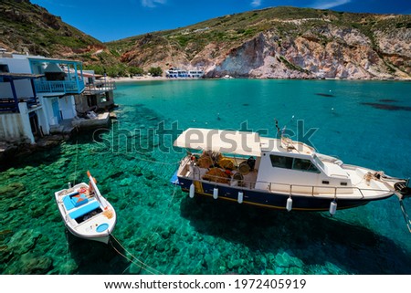 Greek village scenic picturesque view in Greece - fishing boat and fishing village of Firapotamos with beach in Milos island, Greece