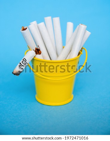 cigarettes in trash can, quit smoking - World No Tobacco Day infocard	