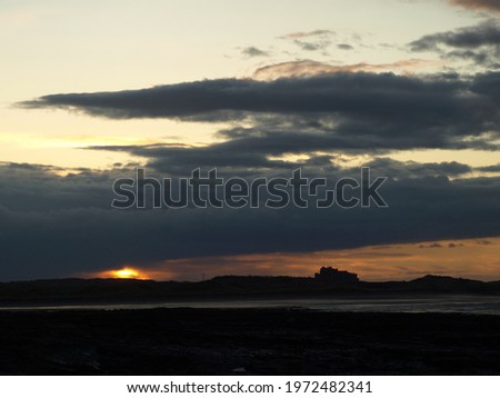 Sunset over Bamburgh from Seahouses harbour