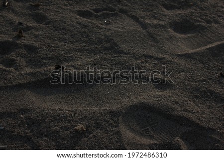 a picture of sand decorated with footprints