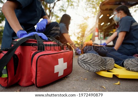 Emergency Medical First aid kit bags of first aid team service for an accident in work of worker loss of function in limbs, First aid training to transfer patient Royalty-Free Stock Photo #1972490879