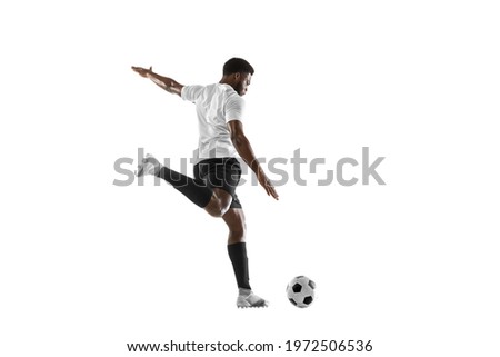 Dribbling the ball. Young African man, male football soccer player training isolated on white studio background. Concept of sport, movement, energy and dynamic, healthy lifestyle. Copy space for ad.