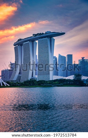 Skyline and view of skyscrapers at sunset in Singapore. Royalty-Free Stock Photo #1972513784