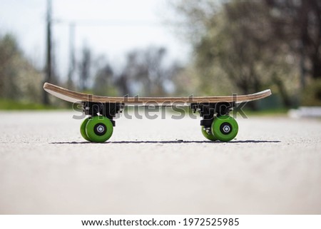 Kids skate with green wheels on the street, transport for sports 