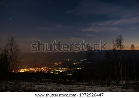 Beautiful panorama of the night city in the Carpathian mountains in winter