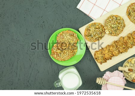 Cookies and milk as a background with space for text. Delicious homemade cookies and milk with honey on rustic wood background