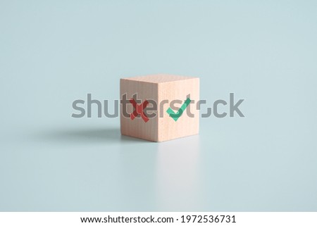 True and false symbols accept rejected for evaluation, Yes or No on wood blogs on blue background. Royalty-Free Stock Photo #1972536731