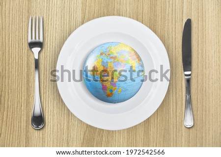Globe on a plate for food. Power, economy, politics, globalism, hunger, poverty and world food concept.