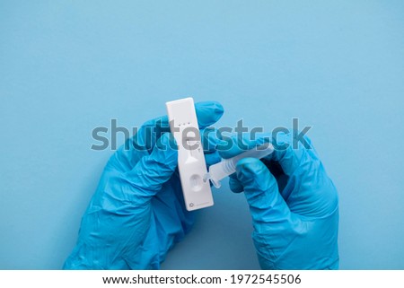 Close up of a person using coronavirus covid-19 rapid antigen home testing kit Royalty-Free Stock Photo #1972545506