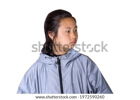 A young girl with a grim expression on her face. Profile of Asian teen girl isolated on white background