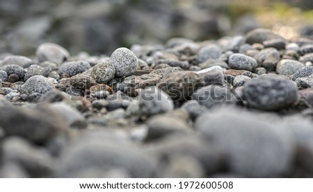 Small round rocks on a river beach Low angle shallow depth of field photo