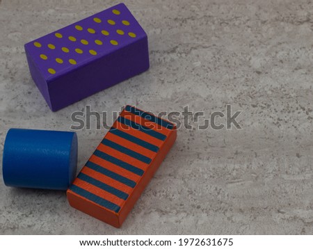 colored toy blocks on clear gray background