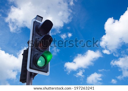 Green Traffic Light with sky, business freedom concept 