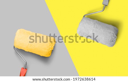 Colors of the year 2021 Ultimate Gray and Illuminating Yellow. Bright paint roller on grey background.