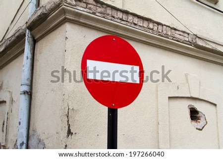 Red stop sign and old wall of building.