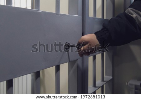 The door of a prison or detention center. Background Royalty-Free Stock Photo #1972681013