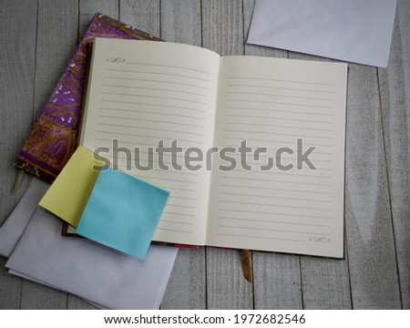 Open Notebook on a wooden desk. 