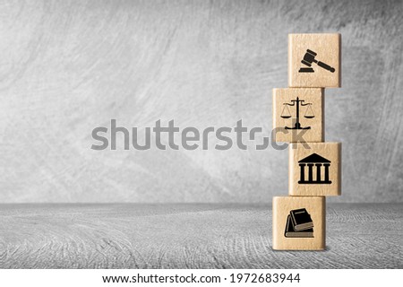 Wooden block cube shape with icon law legal justice on a desk Royalty-Free Stock Photo #1972683944