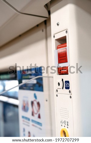 the red emergency door release switch control inside the sky train, it's set up beside the door.