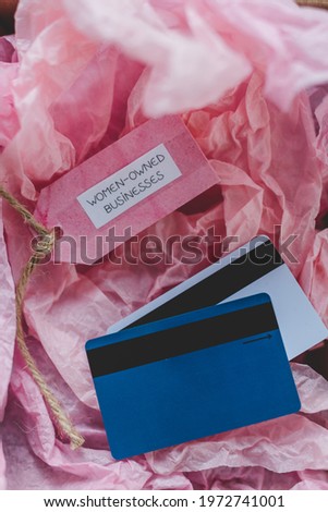 women-owned businesses tag and credit cards inside online order delivery parcel, supporting equality and business growth for female entrepreneurs