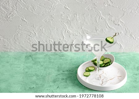 Glass of tasty cucumber martini on table