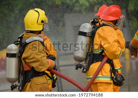 Practice extinguishing the fire Firefighter are using water in fire fighting operationFiremen practice fighting the fire Fireman team fire drills.
