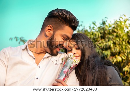 Low angle image of beautiful, happy romantic young couple enjoying date.   Royalty-Free Stock Photo #1972823480