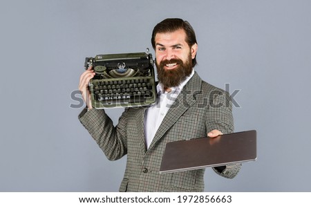 right choice. writer writes with typewriter and laptop. bearded man in jacket with retro type writer. new technology in modern life. Man working on retro typewriter in library. mechanical vs digital
