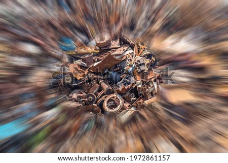 A top down view, zoom blur photo of a giant pile of scrap metal and rusty machine parts of all shapes and sizes.